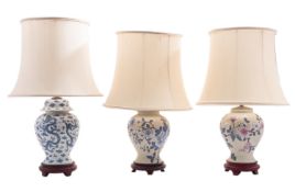 Three glazed ceramic vases, hardwood mounted and fitted as table lamps,