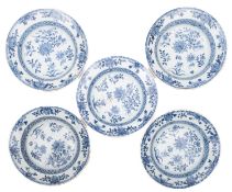 Five Chinese porcelain bowls of shallow circular form each painted in blue with peony and other