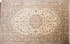 A Kashan carpet, the ivory cartouche field with a central circular pole medallion,