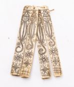 A group of four South East Asian [Batak] engraved and stained bone calendar sticks decorated with