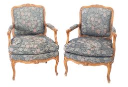 A pair of carved beechwood and upholstered fauteuils in Louis XV taste, modern,