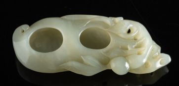 A jade double brush washer of pale celadon colour in the form of a peach, 11cm long.