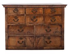 An early 18th Century walnut and feather banded chest on a later stand,