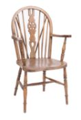 An elm, beech and ash wheelback Windsor elbow chair,