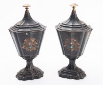 A pair of black lacquered toleware chestnut urns, second quarter 19th century;