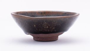 A Chinese Jian-ware 'hare's fur' stoneware tea bowl covered in a black and russet glaze falling