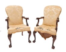 A pair of George II style mahogany and later upholstered elbow chairs,