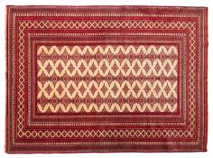 A Turkoman rug, the ivory field with three rows of hexagonal lozenge medallions,