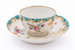 A First Period Worcester teabowl and saucer of fluted form, painted with flower sprays,