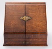 An Edwardian gilt brass mounted oak correspondence box, early 20th century; the hinged,