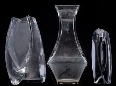 Two Baccarat crystal vases and a candle holder each of asymmetric form,