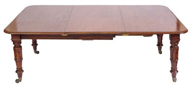A Victorian mahogany extending dining table, circa 1870; the rectangular top with rounded corners,