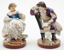 A pair of French bisque porcelain figures of a seated dandy and companion,