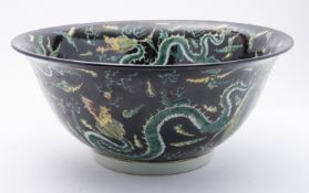A large famille noire 'dragons' punch bowl the interior and exterior decorated with numerous
