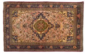 An Aredbil part silk rug, the peach field with a central shaped lozenge pole medallion in indigo,