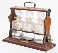 Walker and Hall, 'the Holdfast', an oak and silver plated metal mounted tantalus,