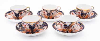 An Imari pattern set of five cups and sa