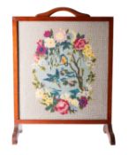 An oak framed and glazed tapestry work fire screen,