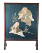 A Japanese silk and wire embroidered panel depicting a musician entertaining a seated figure in a