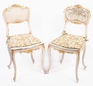 A pair of painted and gilt side chairs i