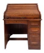 An oak tambour top desk, circa 1915; the