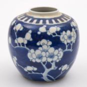 A Chinese porcelain oviform jar painted in blue with prunus. 13cm high, apocryphal Kangxi mark.