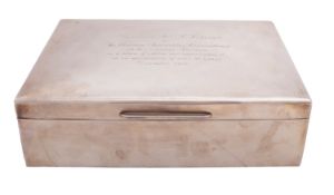 A silver presentation cigarette casket to Mr C. W.