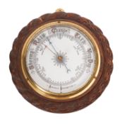 A 20th Century carved mahogany and brass barometer.