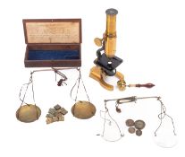 Two cased sets of late 19th century Apothecary's scales,