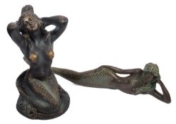 Two composition figures of mermaids.