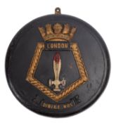 A carved and painted wooden ship's badge for HMS 'London',34cm diameter.