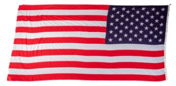 A 20th Century United States 'Star and Stripes' flag with fifty state stars. 230cm high, 437cm long.