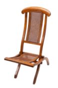 An early 20th century beech folding deck chair. With canework backrest and seat.