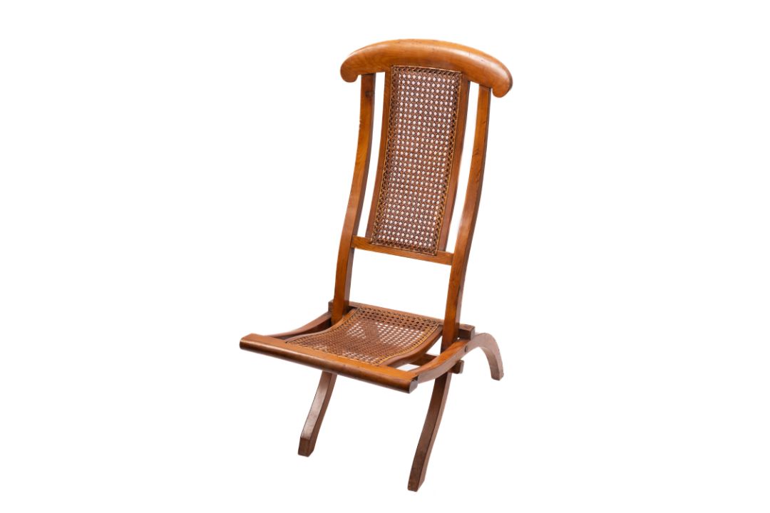 An early 20th century beech folding deck chair. With canework backrest and seat.