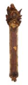 An 18th century continental giltwood thermometer decorated with carved griffin above painted coat