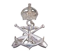 A cast metal Royal Navy pattern PTI badge.
