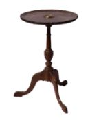 A circular mahogany occasional table with brass inset Nelson plaque.