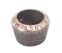 A commemorative steel rivet head inkwell for the Royal Navy Monmouth-class armoured cruiser HMS