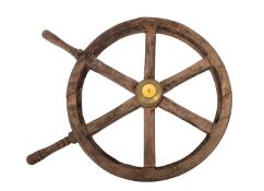 A 20th Century pine ship's wheel. Having two turned handles and a brass centre, 60cm diameter.