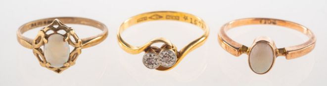 A group of three rings, including a 'toi et moi' two stone ring,