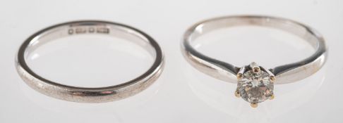 An 18ct gold diamond ring and a wedding band, an 18ct gold diamond solitaire ring,