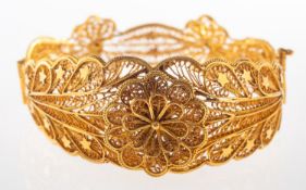 A filigree work bangle, an openwork floral and foliate filigree work bangle,