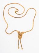A flower lariat style necklace, a square snake chain to a lariat knot with an overlaying flower,