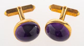 A pair of amethyst set cufflink's, each set with an oval amethyst cabochon, marked 9ct to verso, 8.