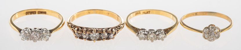 A group of four diamond rings, including a five stone ring set with five graduated old-cut diamonds,