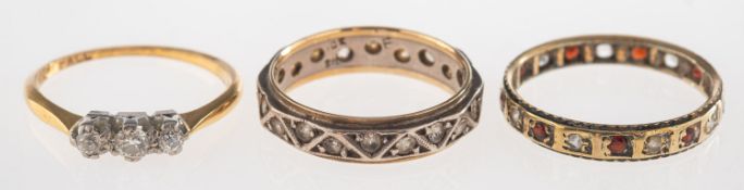 A group of three rings, including a three stone diamond ring, marked 18ct & Plat, size N, 1.