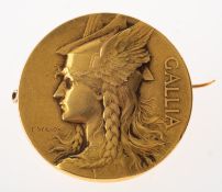 An Art Nouveau Gallia medal brooch, to the front a bust of Gallia wearing a winged helmet,