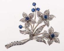 A diamond and sapphire spray brooch, of floral and foliate form,