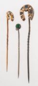 A group of three antique stick pins, a stick pin with horseshoe,