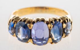 A five stone sapphire ring, claw set with five graduated oval-cut sapphires,
